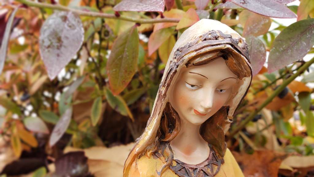 Ceramic lady surrounded by Fall leaves